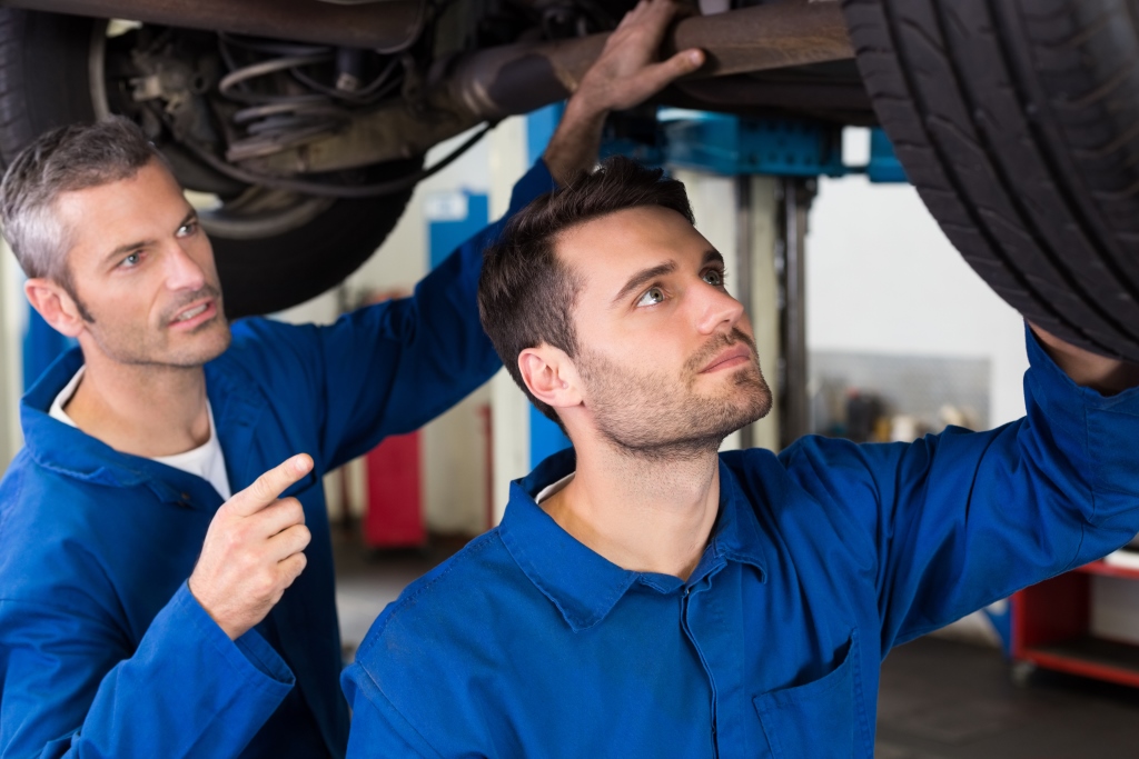 Apprentice working on car